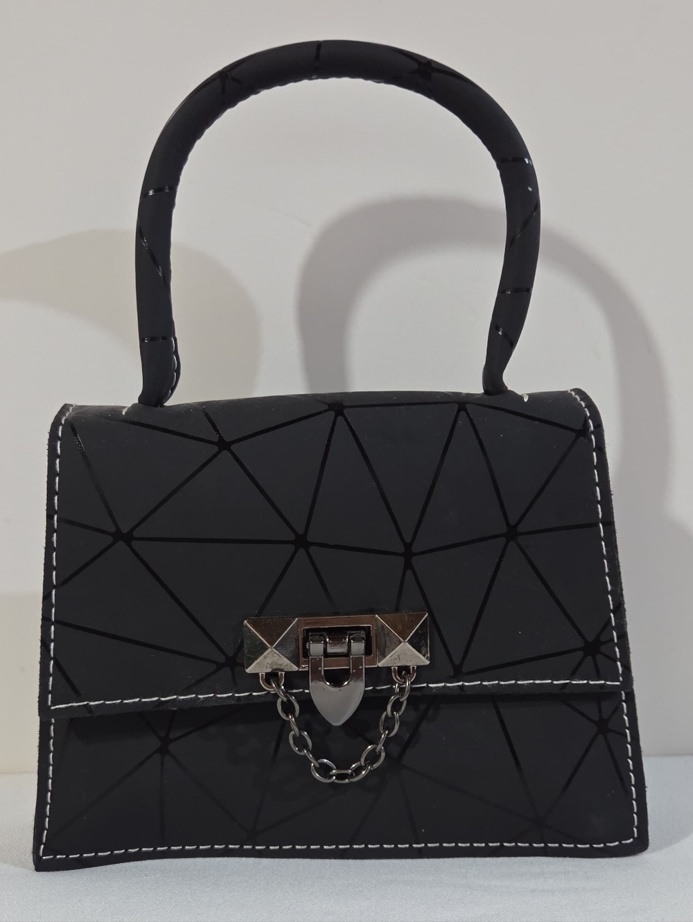 matte black handbag with glossy geometric pattern